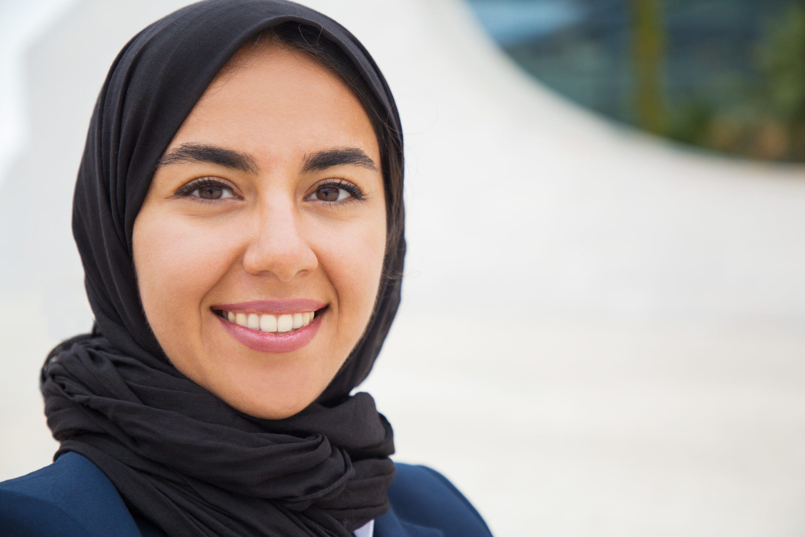 happy confident muslim business lady posing outside